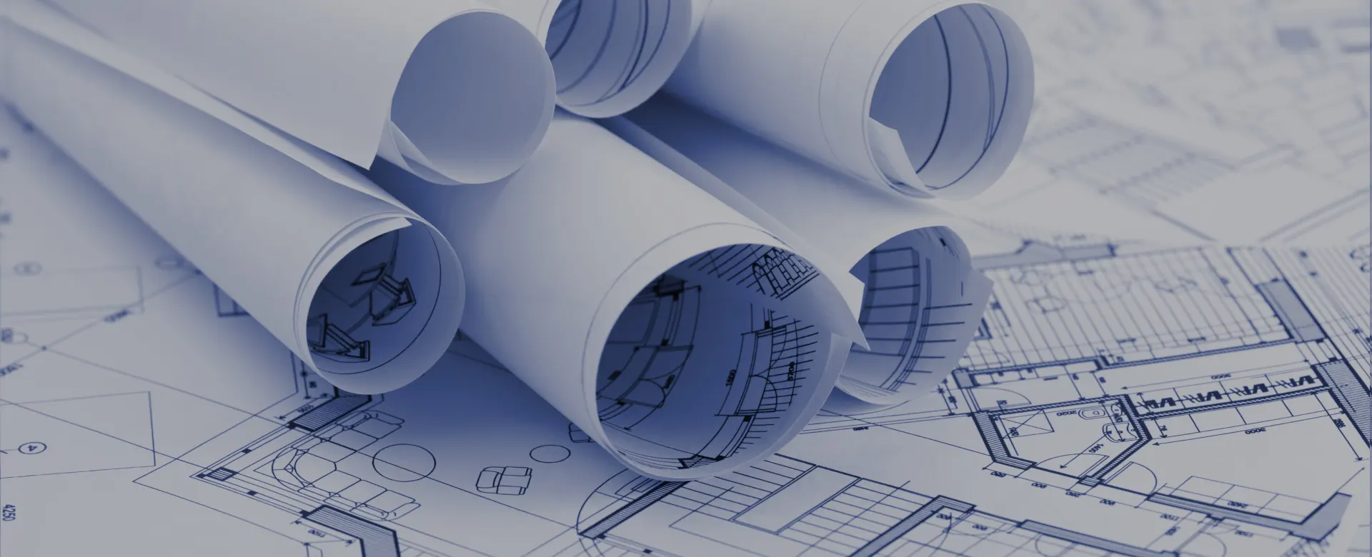 Rolled blueprints on architectural plans